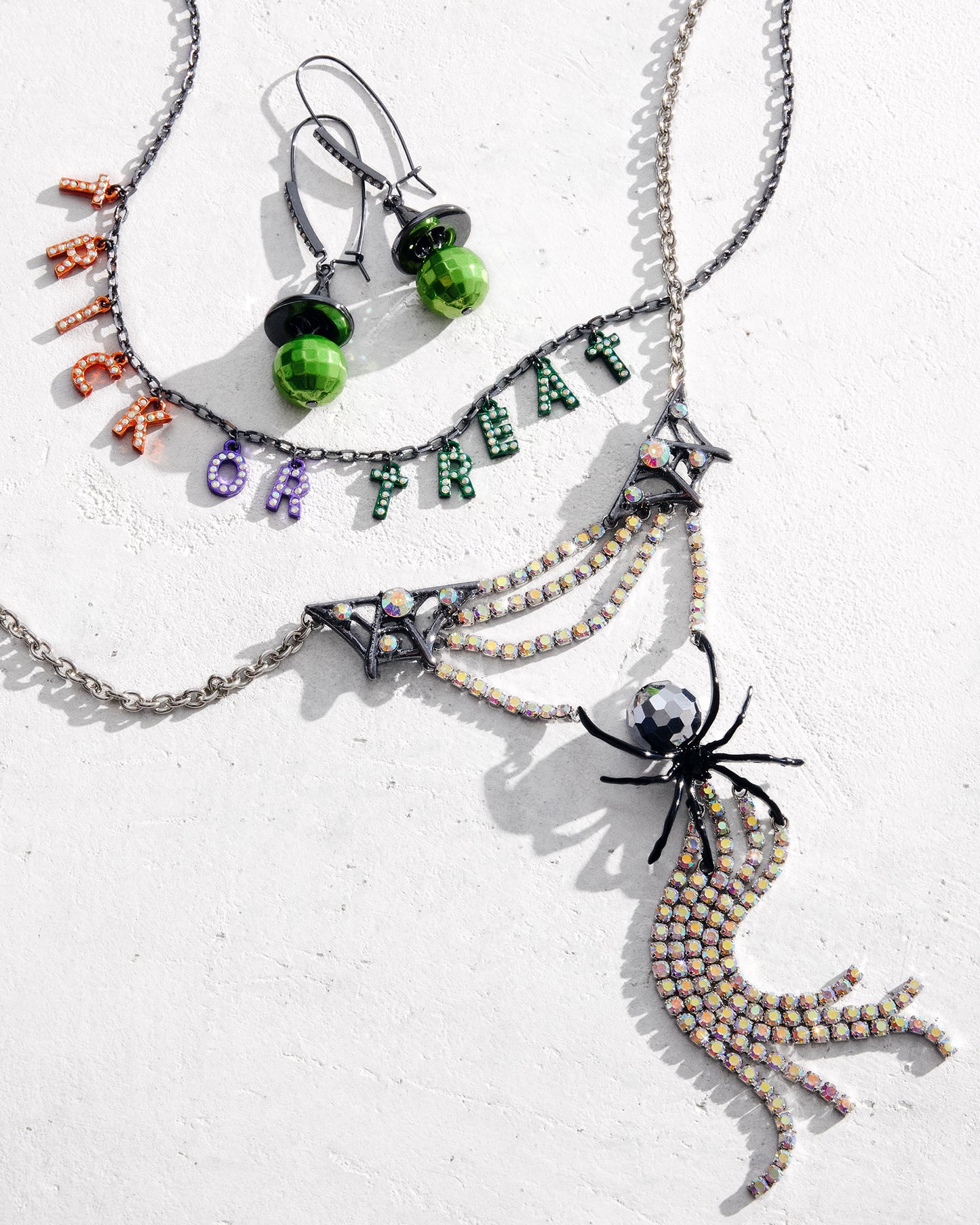 Halloween-themed jewelry set with necklaces and earrings on a white background