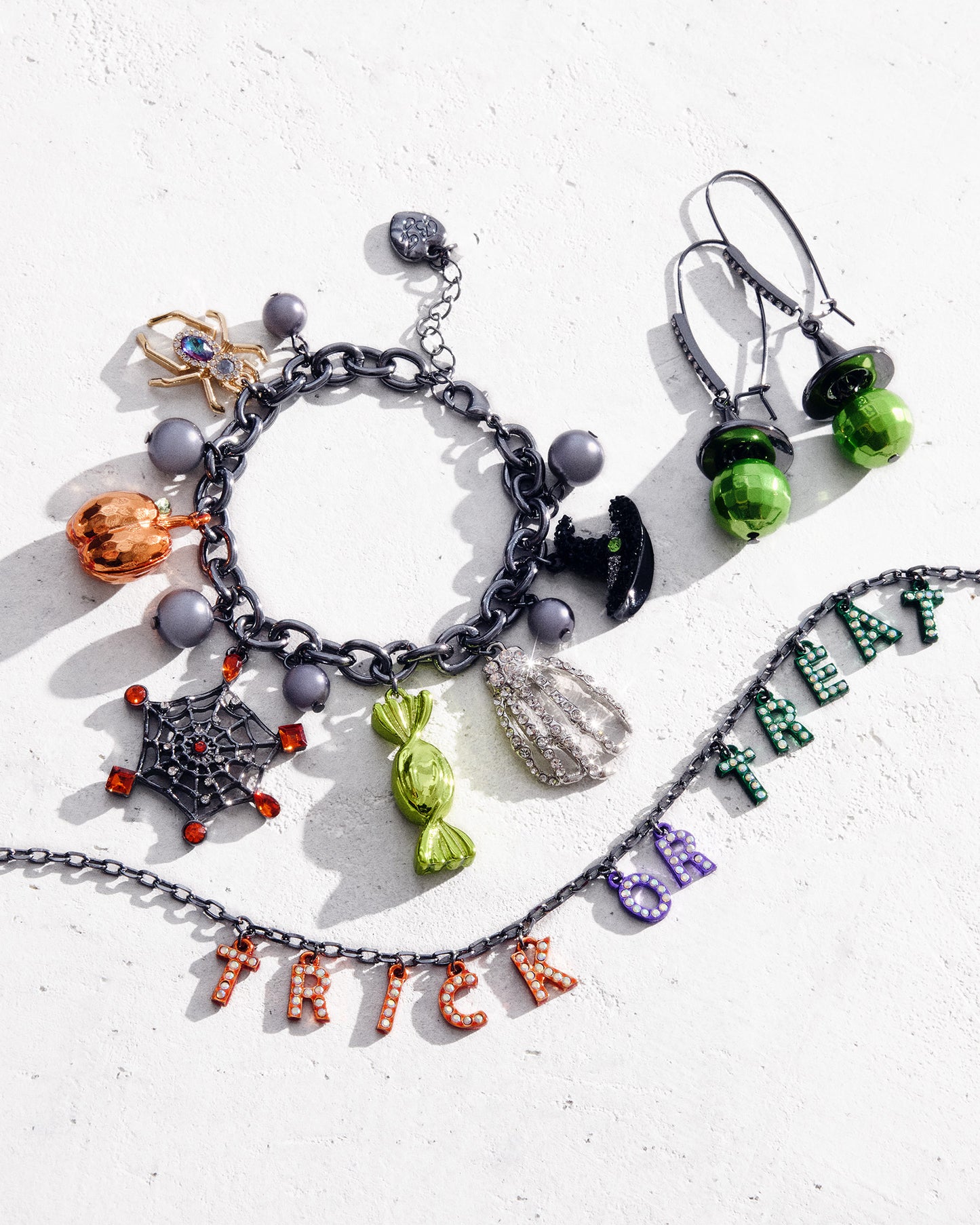 Halloween-themed jewelry set including a necklace, bracelet, and earrings on a white background.