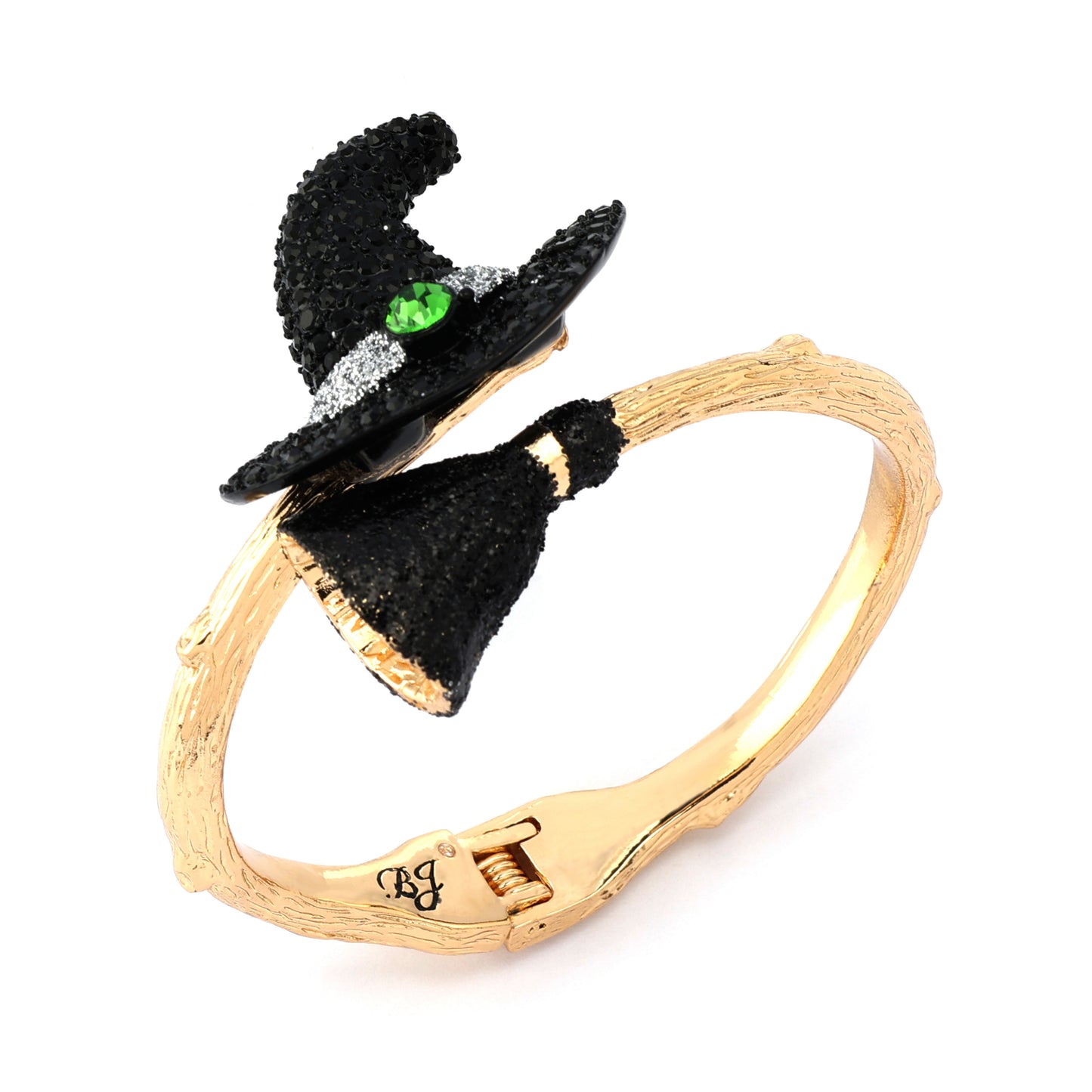 Gold bracelet with black witch hats and a green gemstone on a white background