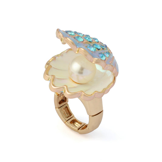 Gold ring with a pearl and blue gemstones on a white background