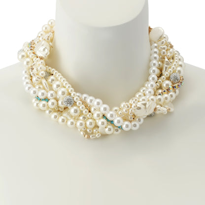 Multi-layered pearl necklace with embedded crystals on a mannequin bust.