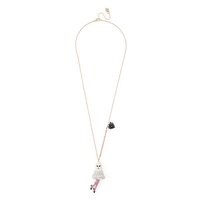 A delicate gold chain necklace featuring a ghost-shaped pendant adorned with rhinestones and pink striped tights, displayed against a solid white background.