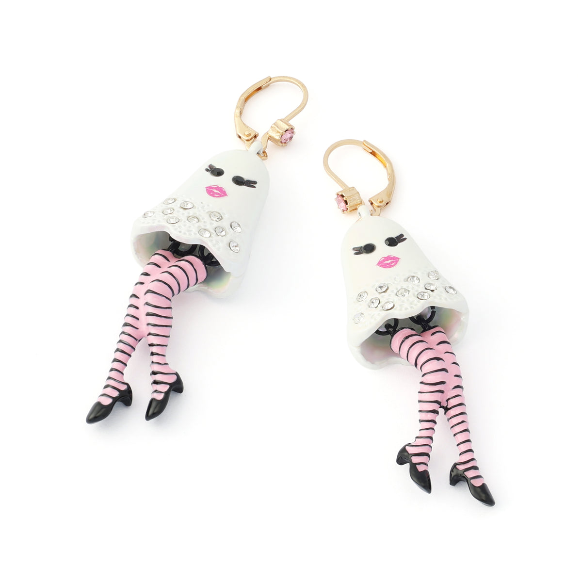 A pair of dangling earrings featuring white ghost-shaped charms embellished with rhinestones, pink lips, and dangling pink-and-black striped legs, suspended from gold-tone hoops on a white background.