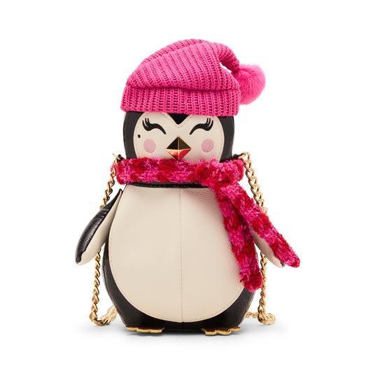 Penguin-shaped handbag with a pink hat and scarf on a white background