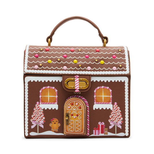 Gingerbread house-themed handbag with decorative elements on a white background