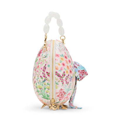 Floral-patterned egg-shaped purse with a gold zipper on a white background