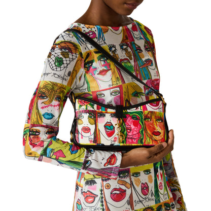 Person wearing a colorful outfit with face patterns and holding a matching bag.