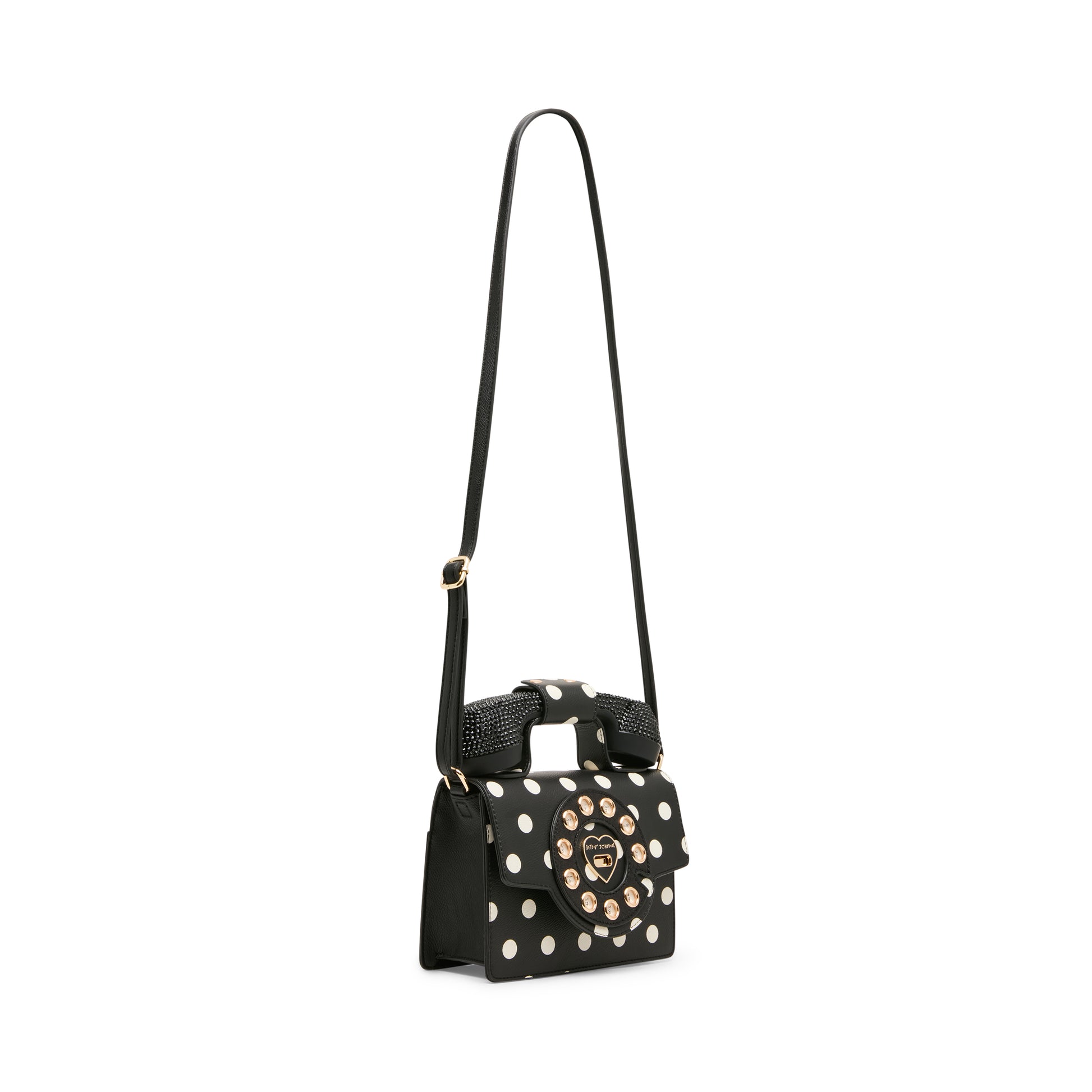 Black handbag with white polka dots and gold accents on a white background