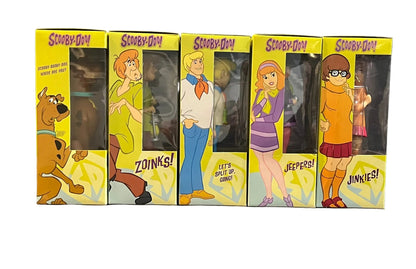 Set of Scooby-Doo figures in their packaging with character illustrations on a white background.