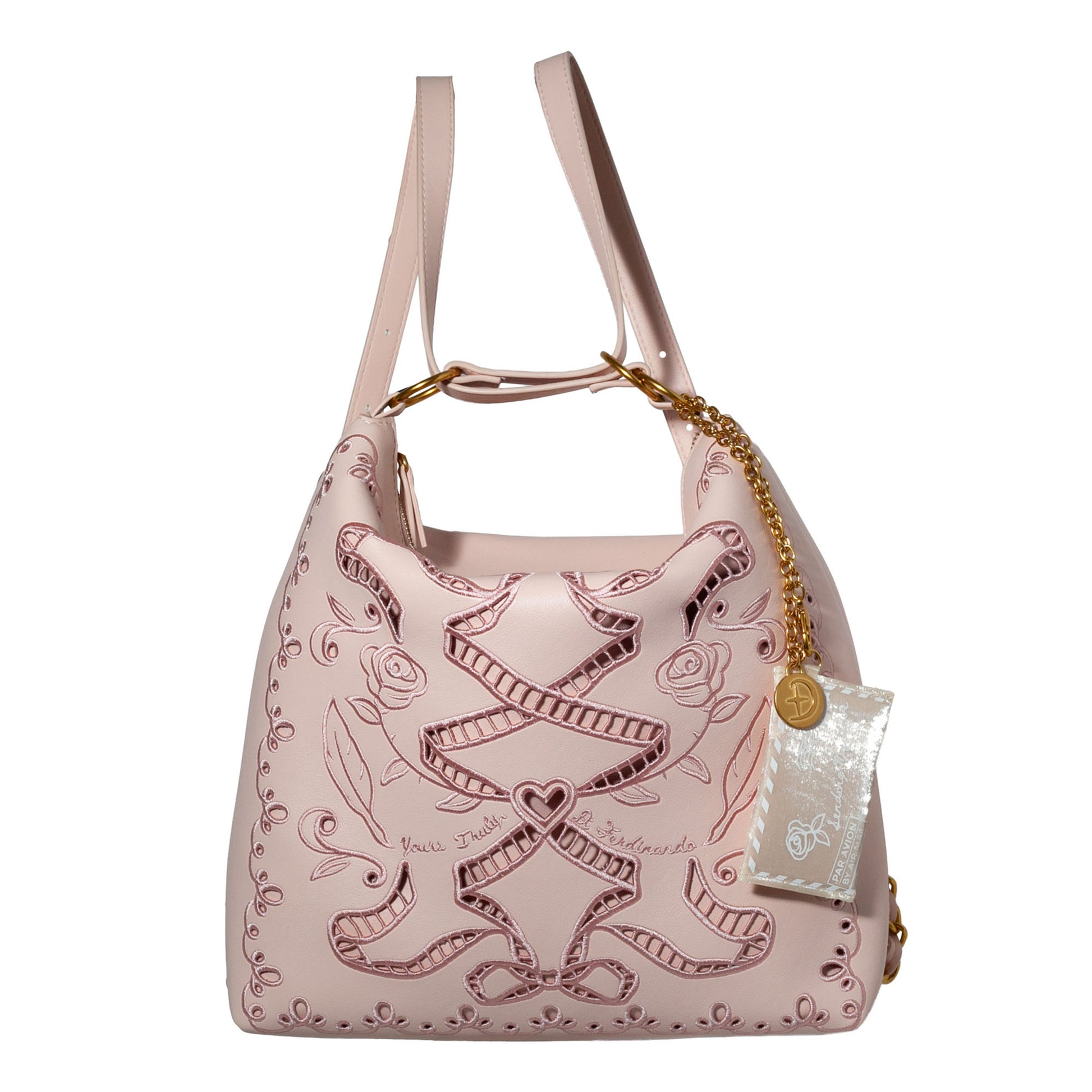 Pink handbag with intricate designs on a white background