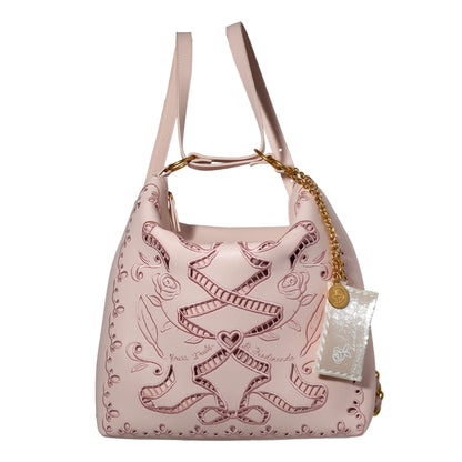 Pink handbag with intricate designs on a white background